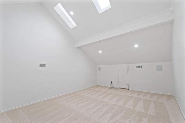 bonus room featuring light carpet, visible vents, lofted ceiling with skylight, and baseboards