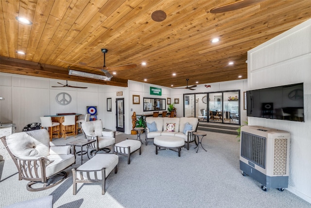 living room with heating unit, wood ceiling, light colored carpet, and ceiling fan