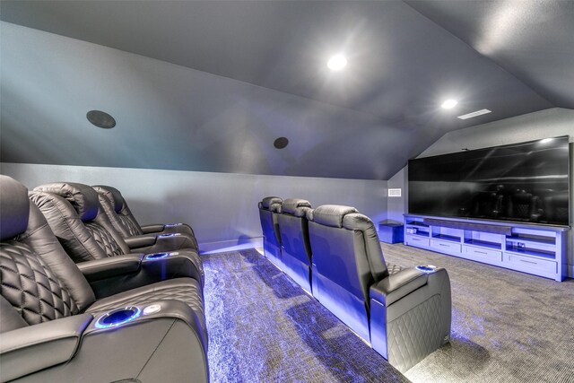 cinema room featuring lofted ceiling and carpet flooring