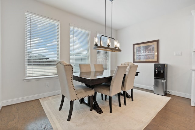 dining space with a chandelier and light wood-type flooring