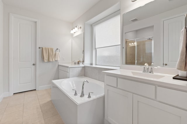 bathroom with vanity, tile patterned floors, and plus walk in shower