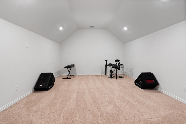 workout area with lofted ceiling and light carpet