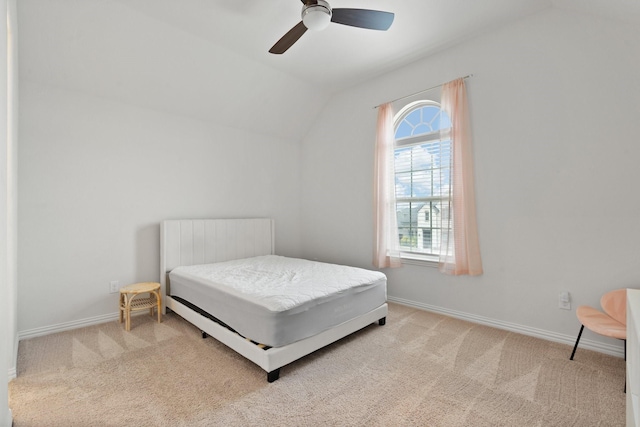 carpeted bedroom with vaulted ceiling and ceiling fan