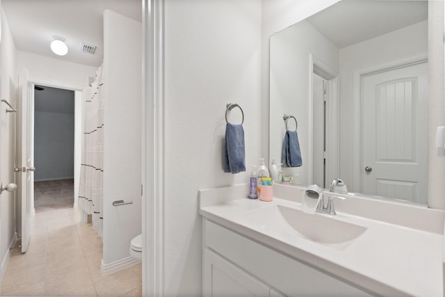 bathroom featuring vanity, toilet, and tile patterned flooring