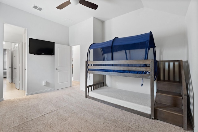 carpeted bedroom featuring lofted ceiling and ceiling fan