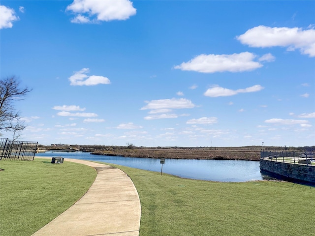 exterior space with a lawn and a water view