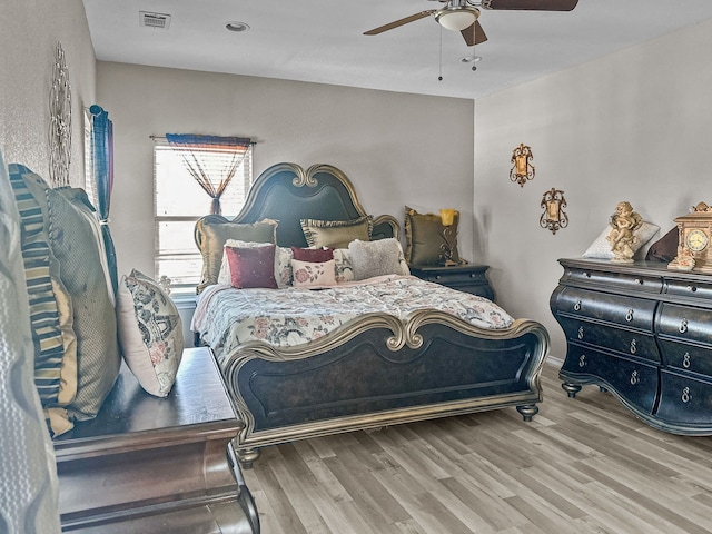 bedroom with hardwood / wood-style flooring and ceiling fan