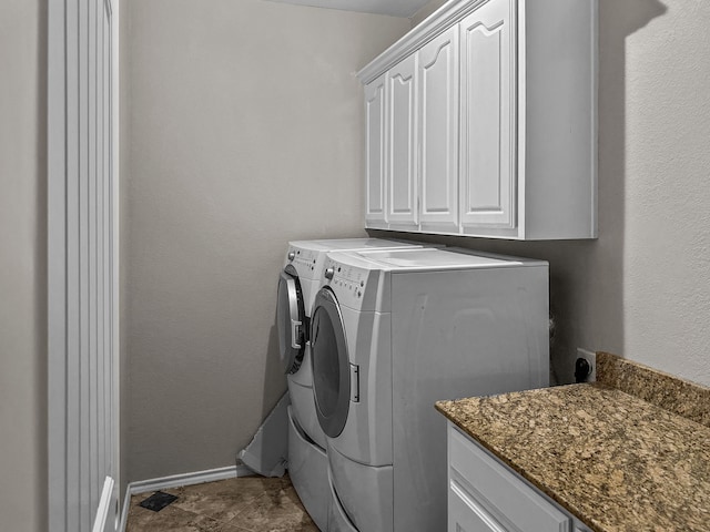 washroom featuring cabinets and independent washer and dryer