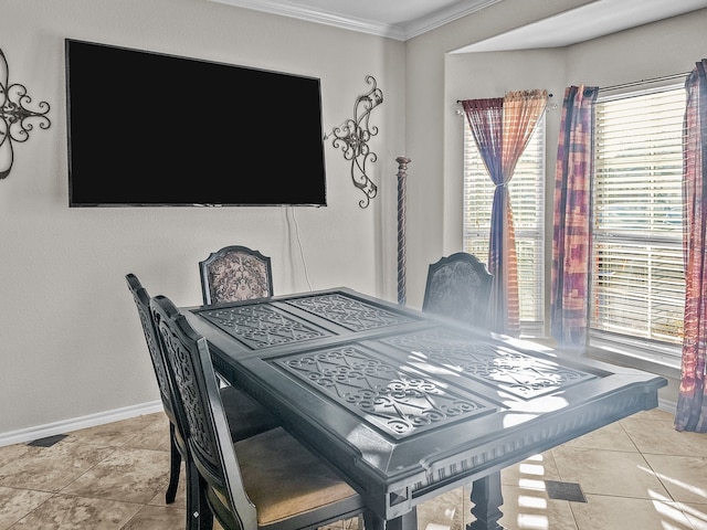 dining room with crown molding and light tile patterned floors