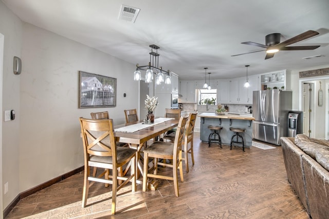 dining room with dark hardwood / wood-style flooring and ceiling fan