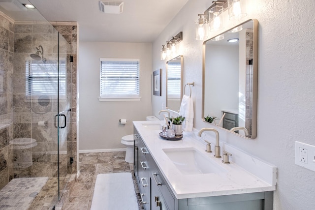 bathroom featuring walk in shower, vanity, and toilet