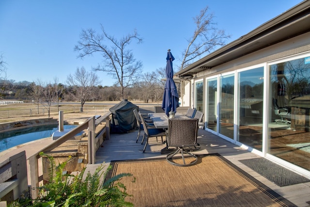 wooden terrace featuring a grill