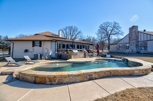 view of swimming pool with a hot tub, a patio, area for grilling, and central air condition unit