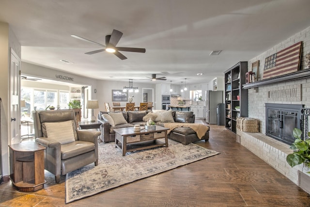 living room with a fireplace, dark hardwood / wood-style floors, and ceiling fan