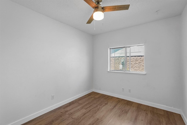 unfurnished room featuring a textured ceiling, wood-type flooring, and ceiling fan