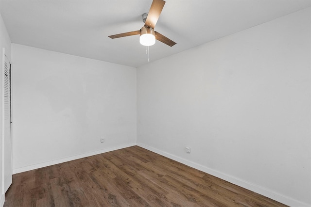 spare room featuring ceiling fan and dark hardwood / wood-style flooring