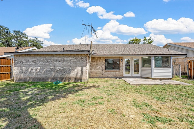 rear view of house with a patio area and a lawn