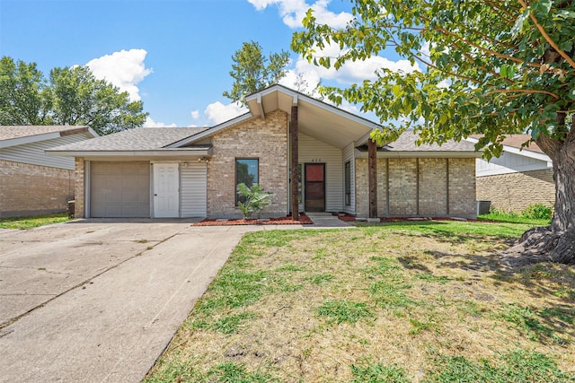 ranch-style house featuring a garage and a front lawn