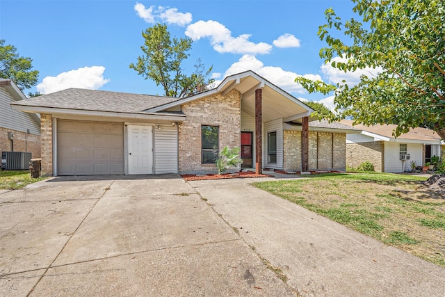 ranch-style home with central AC unit and a garage