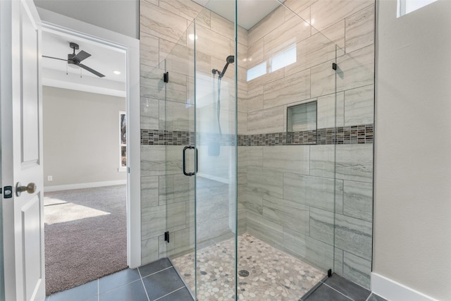 bathroom with tile patterned floors, a shower with door, and ceiling fan