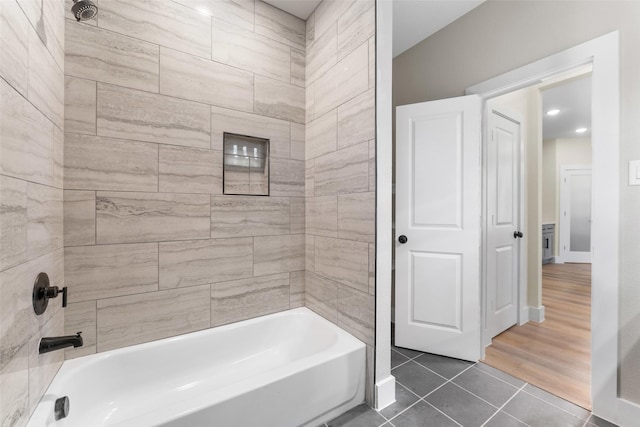 bathroom with tile patterned floors and tiled shower / bath combo