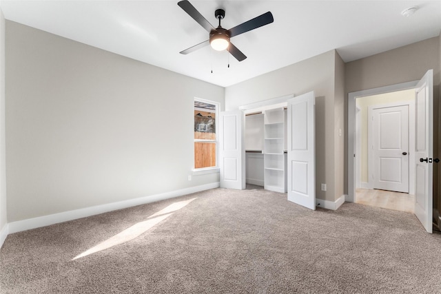 unfurnished bedroom featuring light colored carpet, a closet, and ceiling fan