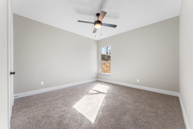 carpeted spare room with ceiling fan