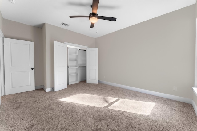 unfurnished bedroom featuring carpet floors, a closet, and ceiling fan