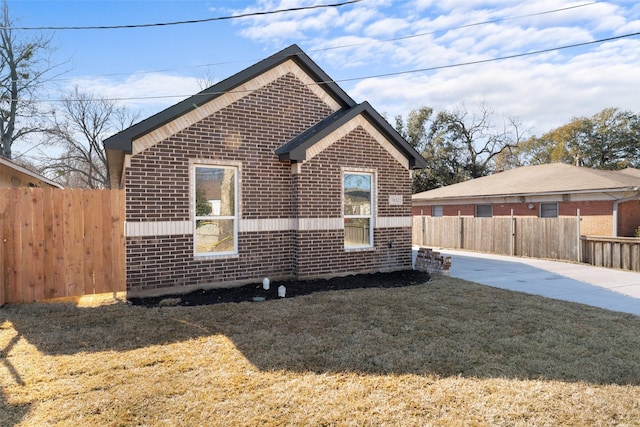 view of side of property with a lawn