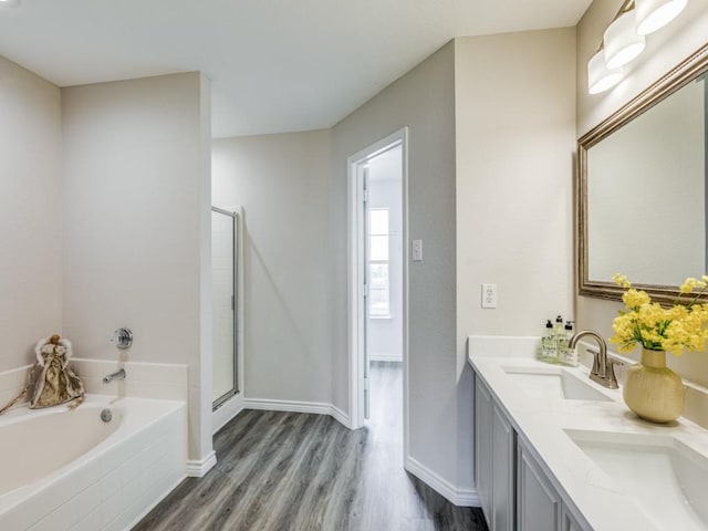 bathroom featuring vanity, hardwood / wood-style floors, and independent shower and bath