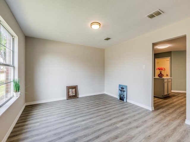 spare room with light hardwood / wood-style floors