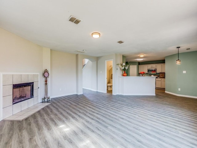 unfurnished living room featuring a fireplace and light wood-type flooring