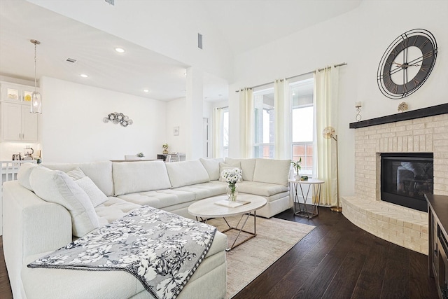 living room featuring dark hardwood / wood-style flooring and a fireplace