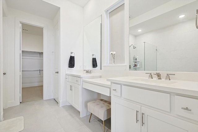 bathroom featuring walk in shower, tile patterned floors, and vanity