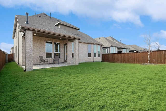 back of house with a yard and a patio