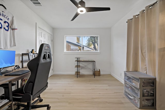 home office featuring ceiling fan and light hardwood / wood-style flooring