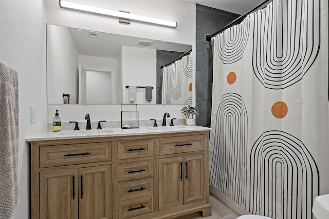 bathroom featuring walk in shower, vanity, and toilet