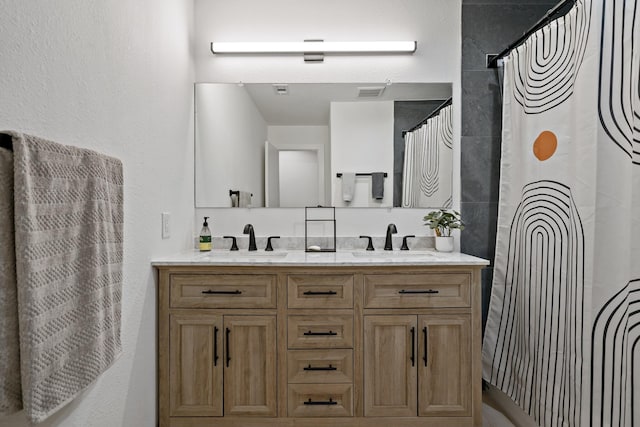 bathroom featuring vanity and a shower with shower curtain