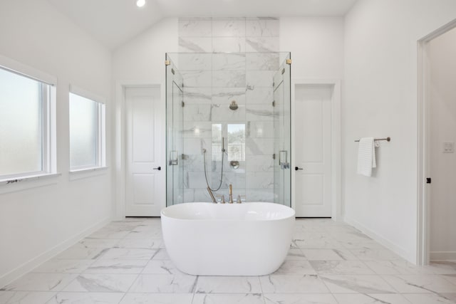 bathroom featuring lofted ceiling, plenty of natural light, and plus walk in shower