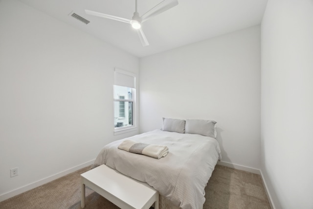 bedroom featuring ceiling fan and carpet