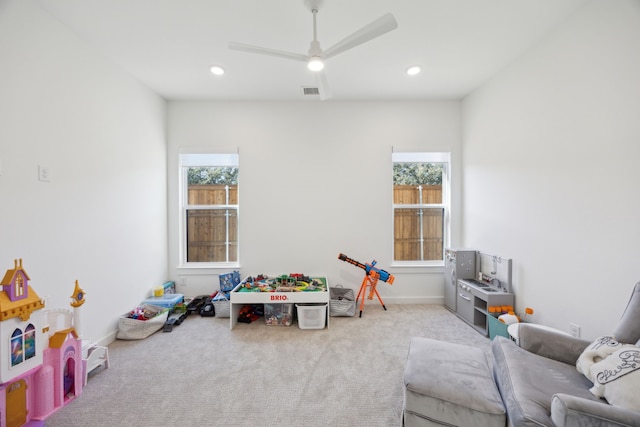 game room with plenty of natural light, light colored carpet, and ceiling fan