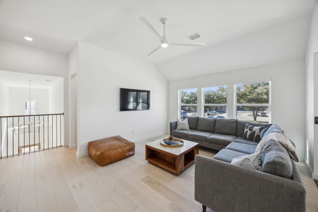 living room featuring vaulted ceiling, ceiling fan, and light hardwood / wood-style floors