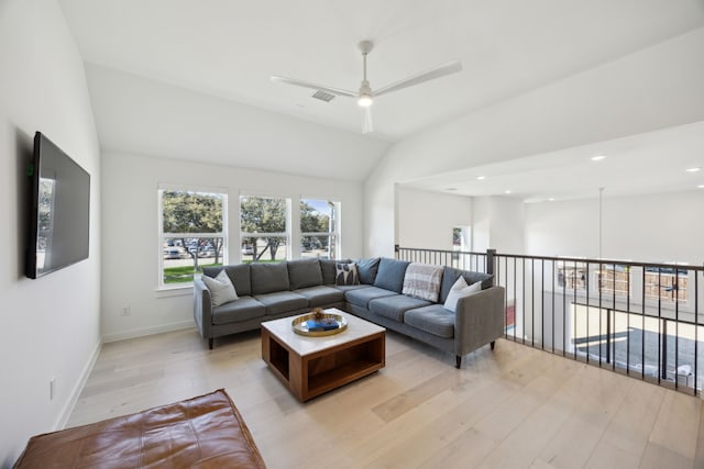 living room with vaulted ceiling, ceiling fan, and light hardwood / wood-style floors