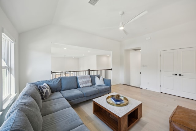 living room featuring vaulted ceiling, a healthy amount of sunlight, ceiling fan, and light hardwood / wood-style floors