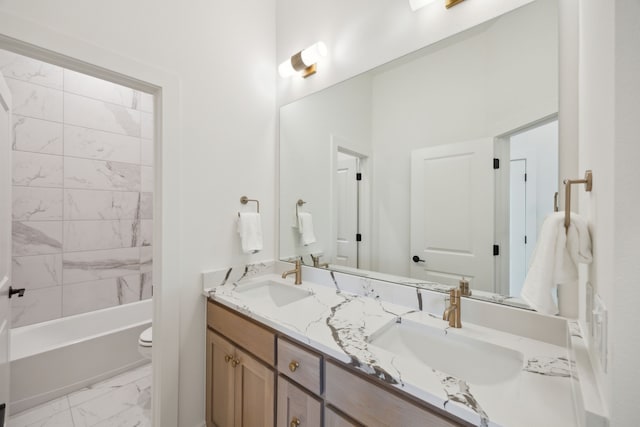 full bathroom with tiled shower / bath, vanity, and toilet