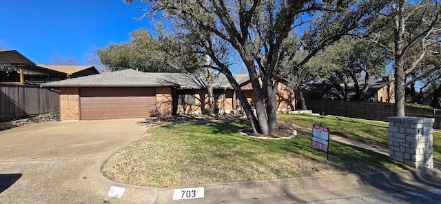 view of front of property with a garage and a front yard