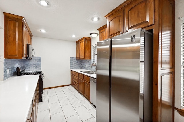 kitchen featuring appliances with stainless steel finishes, sink, and backsplash