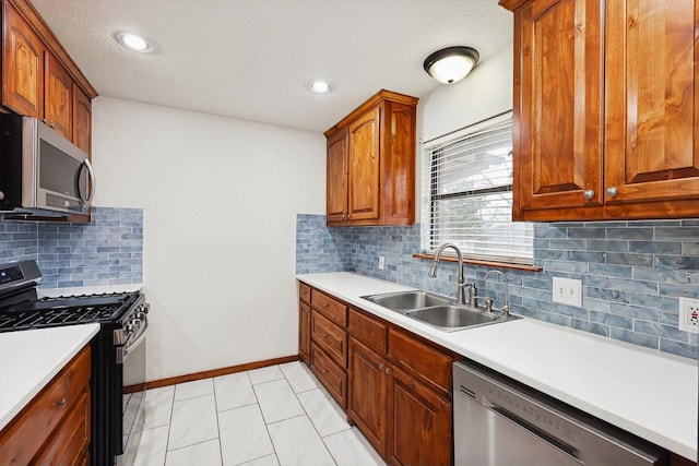 kitchen featuring light tile patterned floors, appliances with stainless steel finishes, sink, and backsplash