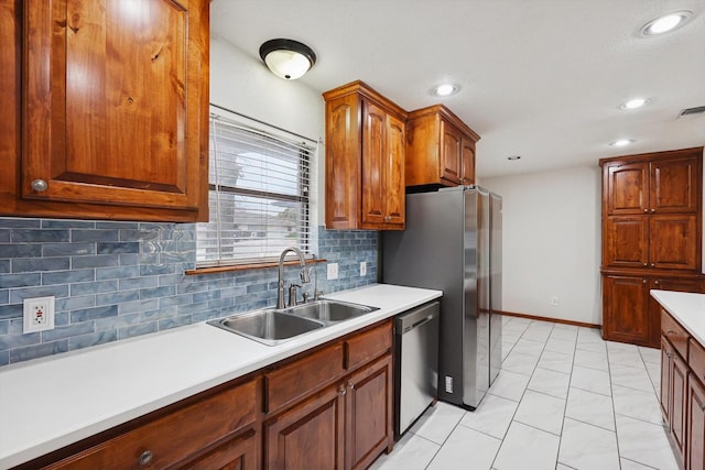 kitchen featuring tasteful backsplash, stainless steel appliances, and sink