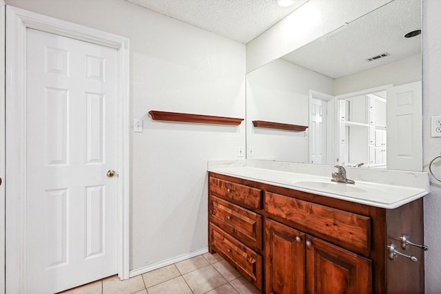 bathroom with vanity, tile patterned floors, and a textured ceiling